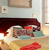 Double bed in bedroom with cushions and bedspread