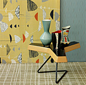Yellow and green contemporary Art Deco style living room with patterned wallpaper carpet coffee table and home wares