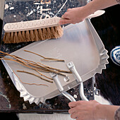 Woman using a dustpan and brush