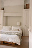 Contemporary neutral decor bedroom with built in cupboards in alcoves