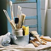 Containers with unused paint brushes and decorating tools