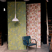 Panels of wallpaper amongst a basement storage room