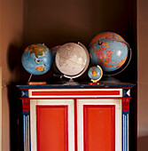 Collection of globes on a painted unit