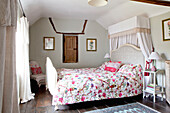 Quilted bed cover in bedroom of old UK home