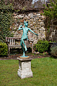 Garden statue of a man aiming a bow and arrow, UK