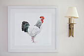 Artwork of a cockerel and wall sconce in Surrey cottage England UK