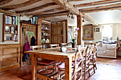 Wooden table and chairs in beamed kitchen of Ripley home West Yorkshire England UK