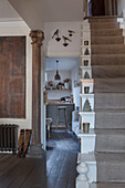 Ornaments on open stairs with architectural pillar in Hove home East Sussex England UK