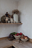 Vegetables and ceramics on wooden workbench in Hove kitchen East Sussex England UK