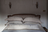 Upholstered linen headboard and pillows in Hove bedroom East Sussex England UK