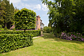 Lawned path with beech hedge in grounds of 1920s country house, Haslemere, Surrey, UK
