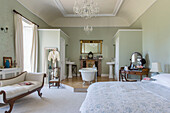 Freestanding bath in spacious en suite bedroom suite of historic Somerset country house UK