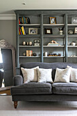 Grey sofa and bookcase in living room of Guildford townhouse Surrey UK
