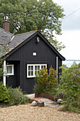 Black painted home exterior with gravel driveway in Gurnard isle of Wight