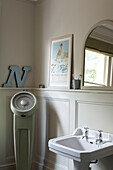 Panelled bathroom with pedestal base wash hand basin and weight scales