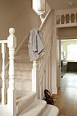 White painted banister on carpeted staircase of London home