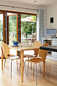 Light wood kitchen table with concertina patio doors