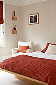 Co-ordinated bed cover and cushions in London home