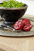 Pomegranate and salad bowl on silver tray in Sydney home Australia
