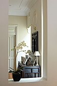 View through alcove with orchid to sideboard in Sydney home Australia