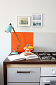 Desk lamp on kitchen worktop with open recipe book in Isle of Wight home UK