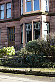 Bay window and front garden of Scottish apartment building UK