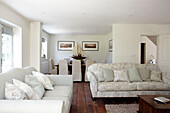 White painted open plan living and dining room in Bembridge farmhouse, Isle of Wight, England, UK