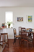 Retro style kitchen table and chairs with artwork in Bembridge home, Isle of Wight, UK