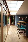 "Bar stools and skylight in kitchen with g;ass patio doors in contemporary Isle of Wight home UK"