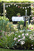 Water fountain and bunting in back garden of Wiltshire home, England, UK