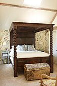 Dark wooden four-postered bed in Wiltshire home, England, UK
