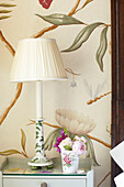 Cream lamp with cut roses in Wiltshire country home, England, UK