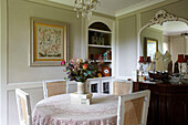 Framed artwork and model boat in dining room of East Cowes home, Isle of Wight, UK