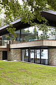 Modern facade of Binstead new-build with timber cladding and pebble-dashed lower storey Isle of Wight, UK