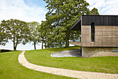 Modern facade of Binstead new-build with timber cladding and pebble-dashed lower storey Isle of Wight, UK