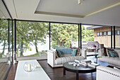 Full length windows in seating area with view to the Solent from modern Isle of Wight home UK