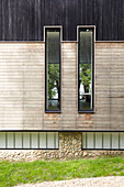 Modern facade with timber cladding and pebble-dashed lower storey Isle of Wight, UK