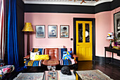 Bright yellow blue and pink living room in Hastings townhouse East Sussex England UK