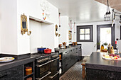 Black kitchen with cobblestone floor in Hastings townhouse East Sussex England UK