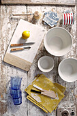 Tableware and napkins with lemon on chopping board