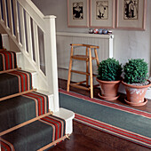 Green red and beige capet runners in hallway and up the staircase