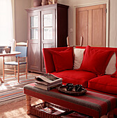Bright red sofa and cushions in country style living room