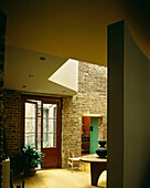 View into dining room with with exposed brickwork walls and curved wall