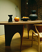Dining room with bespoke oval wooden table and African pot and bowl