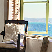 Chair in window with sea view