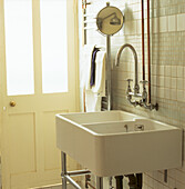 White tiled bathroom with double sink
