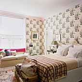 Bedroom with pretty floral pattern wallpaper and sofa