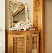 Mirror and coral on chest of drawers