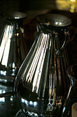 Close up of antique silvered glass decanter reflected in mirror