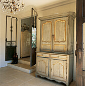 Entrance Hall with metal gate and decorative French dresser and chandelier